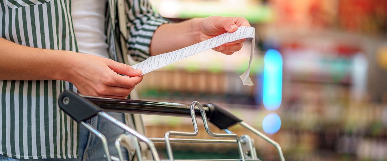 grocery store with well-stocked shelves filled with fresh produce, canned goods, and household essentials. Promotional sale tags and discount